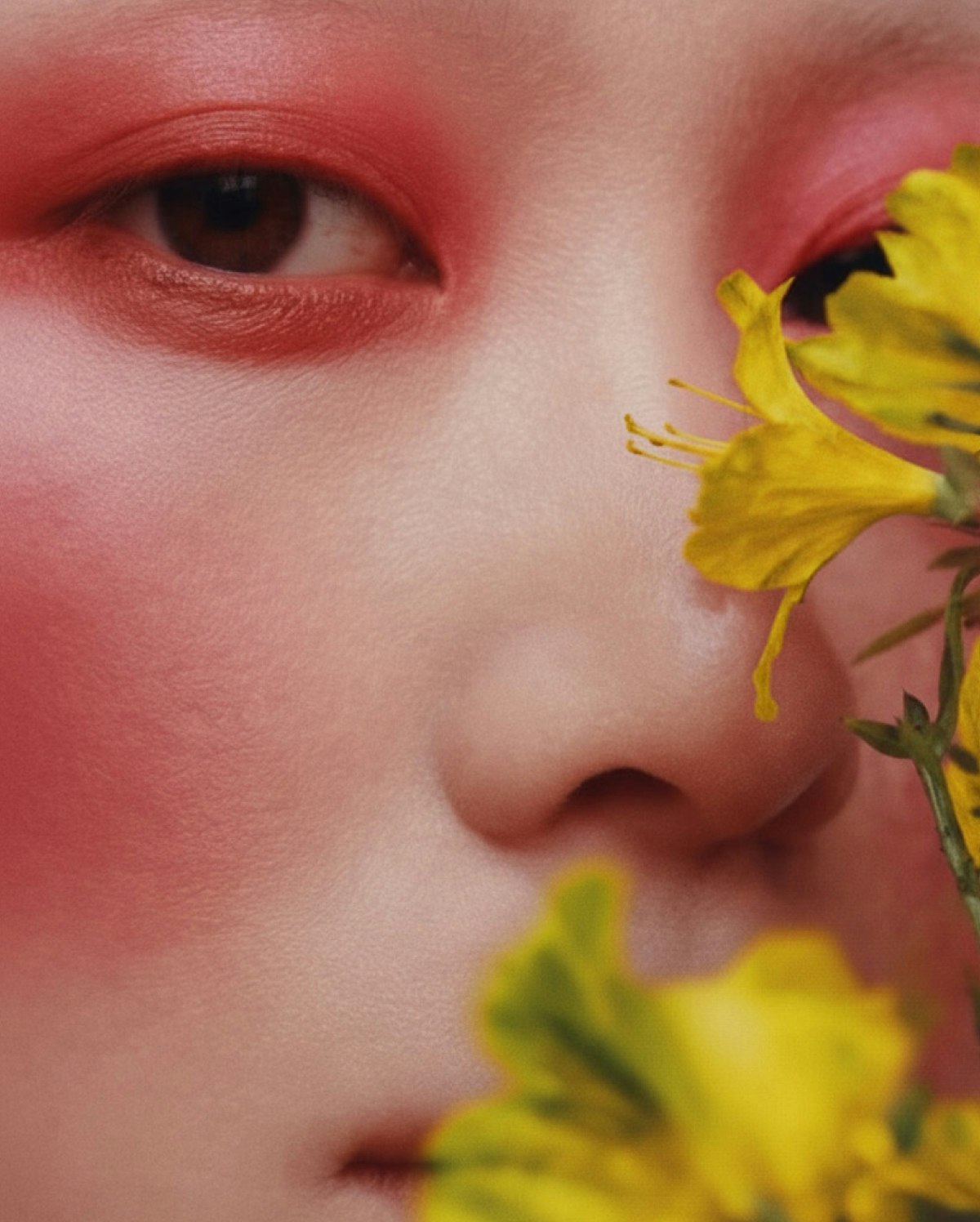 Creative portrait framed by vivid red flowers